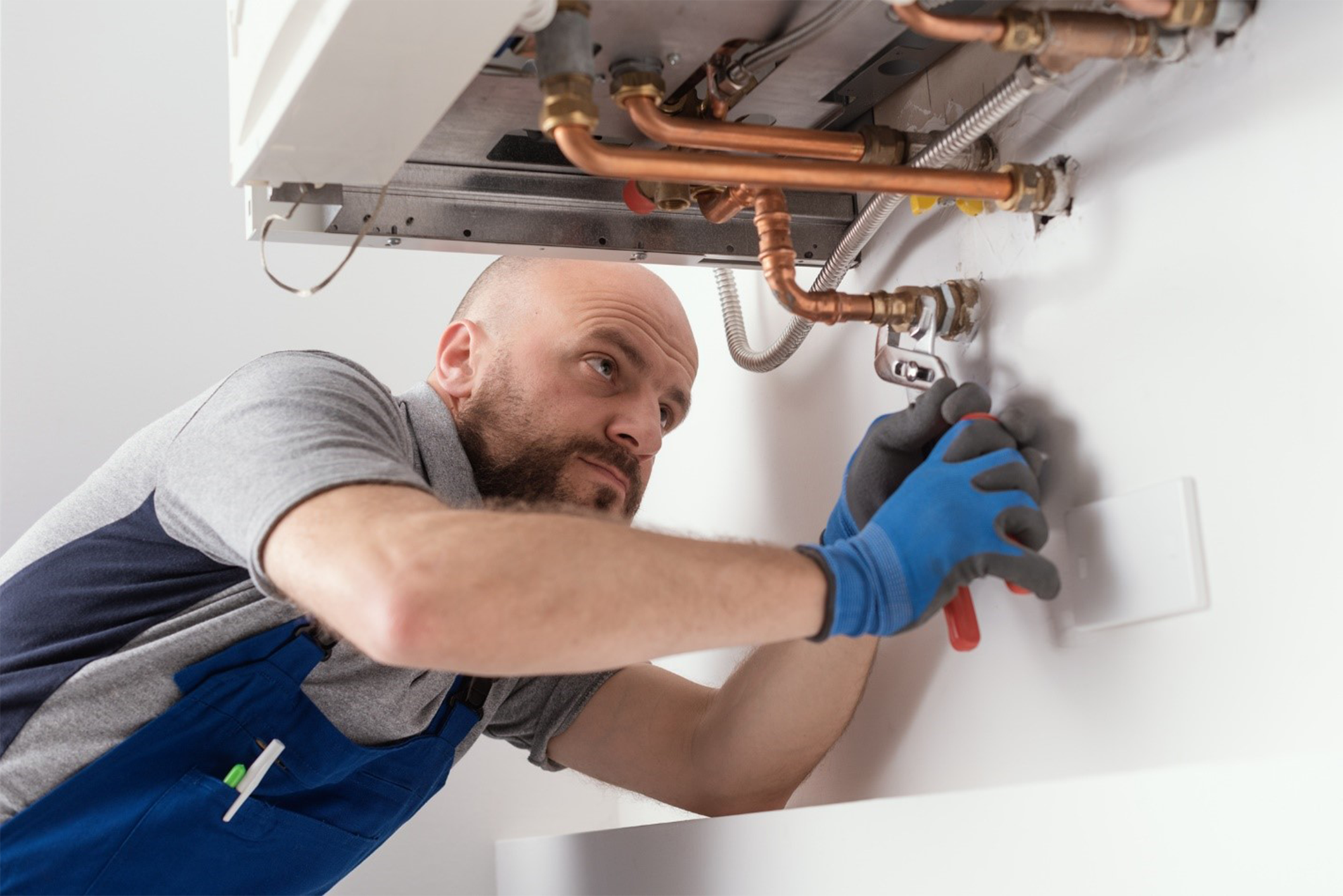 HVAC technician performing a maintenance service on a home boiler