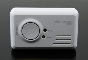 Carbon monoxide alarm on black background.