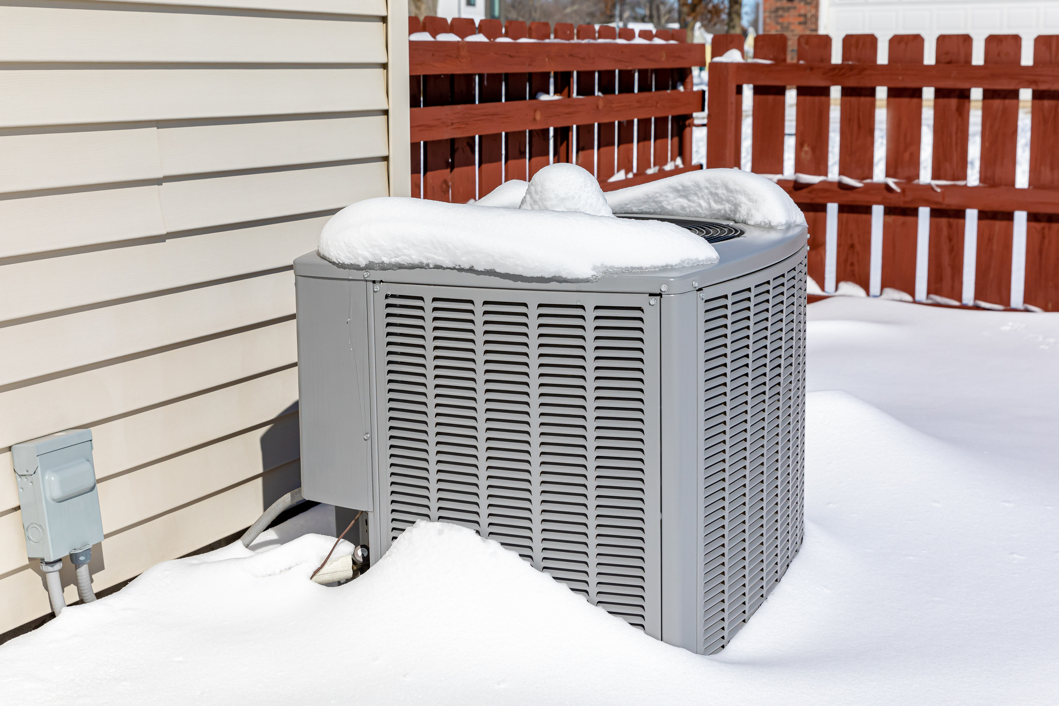 An Ohio outdoor HVAC unit covered in snow