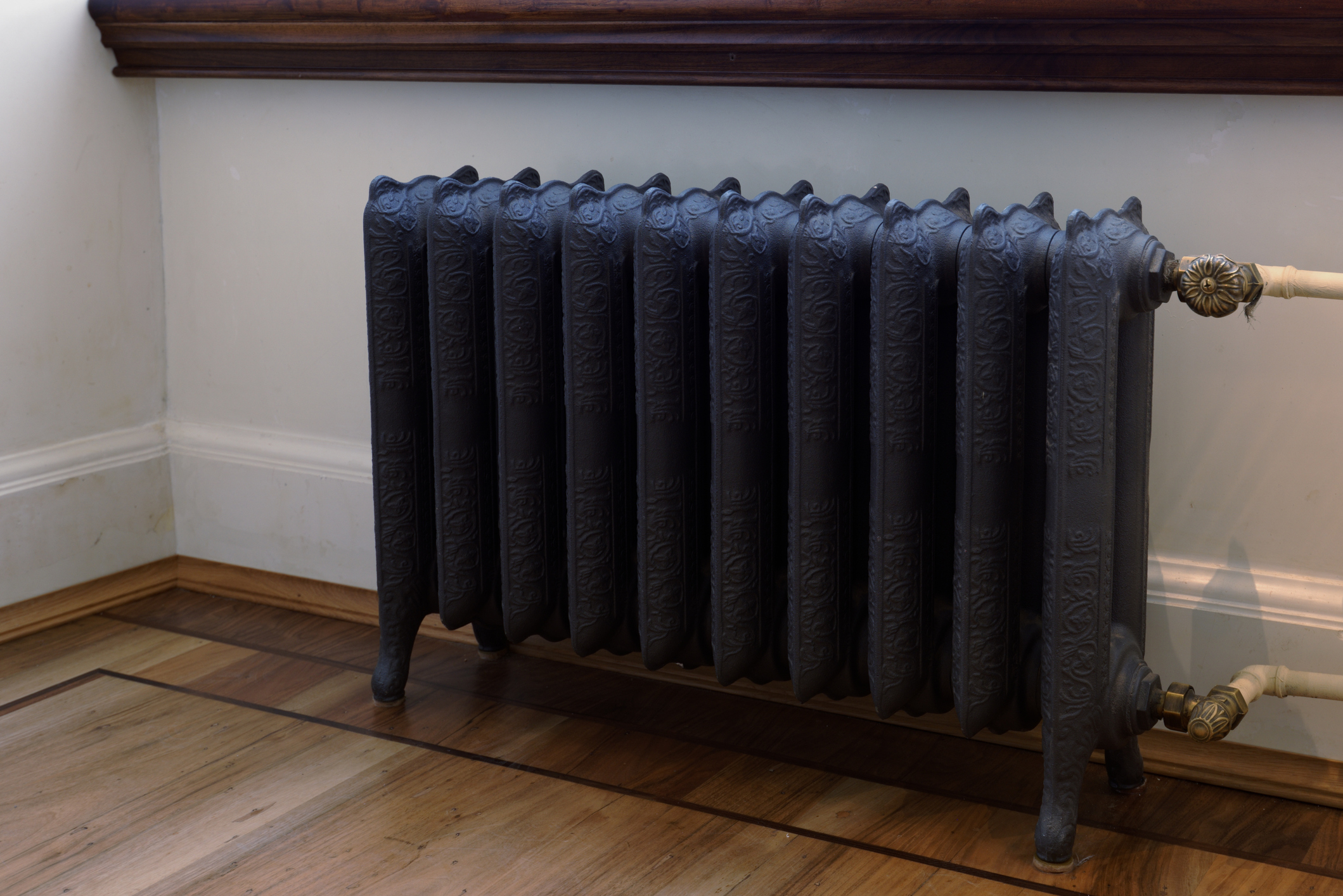 Cast iron radiator against a white wall